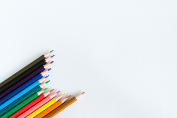 Colored pencils on white background with space for text.  Сolourful pencils isolated templates to be used as background.
