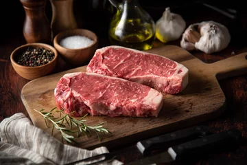 Foto auf Alu-Dibond raw strip beef steak meat on wooden cutting board © ahirao