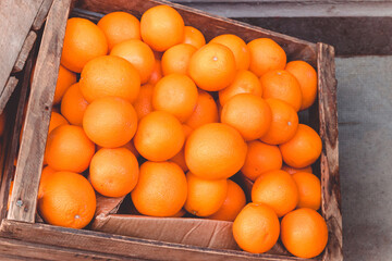 Top view fresh oranges in a wooden box