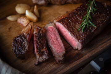 dark image of sirloin beef steak on wooden board