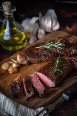 dark image of sirloin beef steak on wooden board
