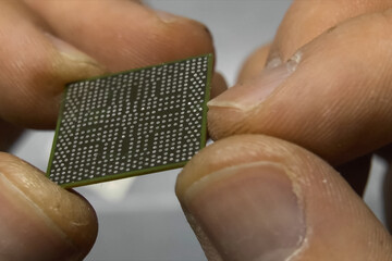 recovered computer microprocessor chip is in the hands of a man.