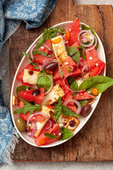 Salad with watermelon, cheese halloumi and spinach