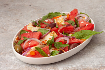 Salad with watermelon, cheese halloumi and spinach