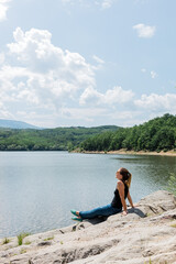 Fototapeta na wymiar Young woman enjoying great outdoors by the lake