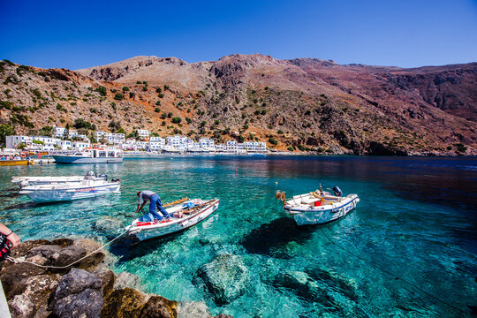 Boats on a transparent water in Loutro village, Crete island, Greece