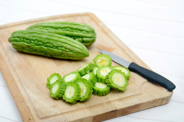 sliced bitter melon on a wooden board