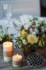 wedding table decoration, candles, flowers in a vase