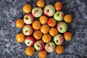 Tasty and healthy berries. Fruit season. Fruit season. Ripe apples and apricot lying on the table.