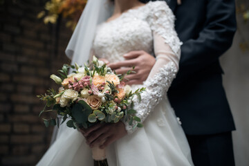 wedding bouquet of the bride, flowers on the background of people who are hugging