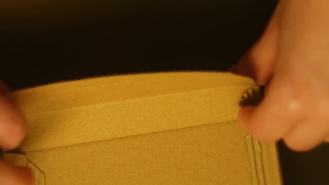 Close up hands assemble paper box. Hand made package for present