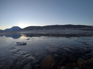 cold frozen river stream in late autumn