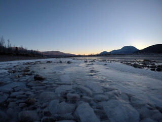 cold frozen river stream in late autumn