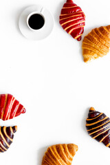 Set of coffee with croissants - chocolate, berry, classic - on white top view