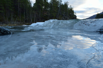 cold frozen mountain creek with ice buildup