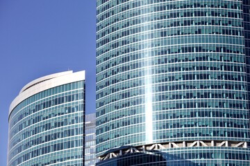 Office and residential skyscrapers in city downtown close up. Commercial real estate. Financial city district. Modern business city district. Office buildings exterior and facade design. In the city.