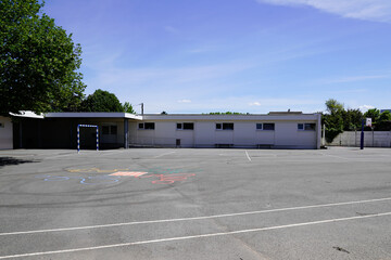 school building and sporty schoolyards child exterior with kids playground