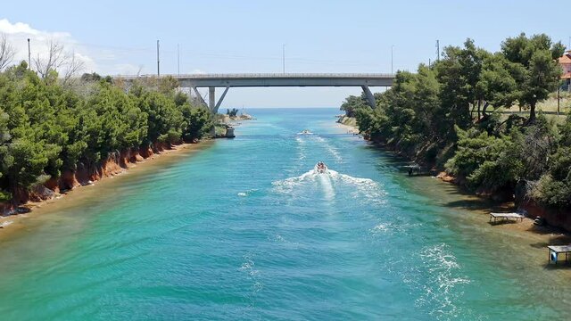 Aerial footage of two motor boats crossing Nea Potidea canal, which connects Toroneos Bay with the Gulf of Thermaikos. Greece, Kassandra, Halkidiki
