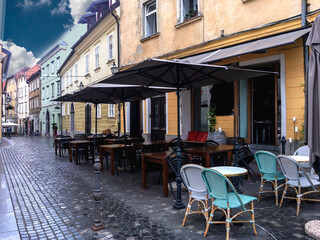 Cozy summer cafe in the old town near the river in the rain