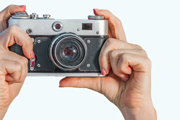 Retro camera in female hands close-up on a white background. Woman hands holding retro camera isolated on white background