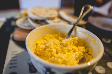 White bowl with homemade fresh egg salad and toasts in a table