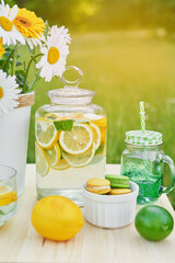 Lemonade and daisy flowers on table. Mason jar glass of lemonade with lemons. Cozy morning. Spring and summer season card. Healthy Food and Drink. Summer holidays. Outdoor picnic. Mother's day card
