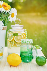 Lemonade and daisy flowers on table. Mason jar glass of lemonade with lemons. Cozy morning. Spring and summer season card. Healthy Food and Drink. Summer holidays. Outdoor picnic. Mother's day card