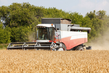 Combine harvester working in a very wide wheat field