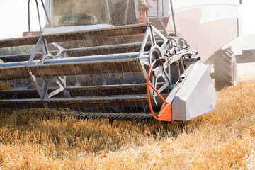 Combine harvester working in a very wide wheat field