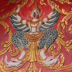 Religious bird image fresco on a red wall of a wat in Siamese Lao PDR, Southeast Asia
