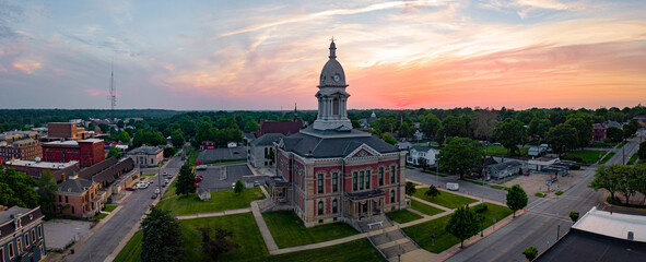 A small town courthouse during a sunset.