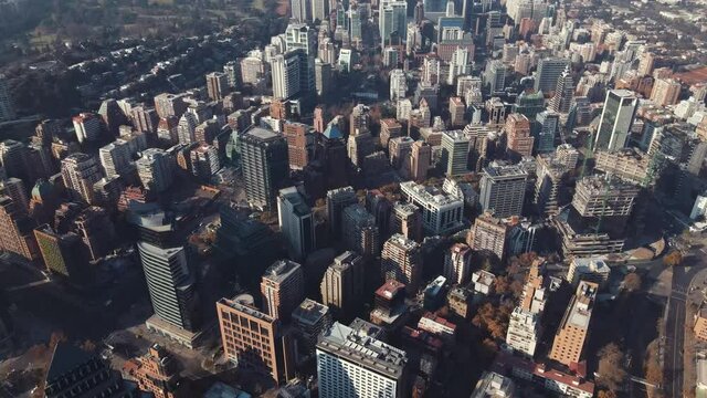 Aerial over concrete jungle on a sunny afternoon in Santiago, Chile-4K