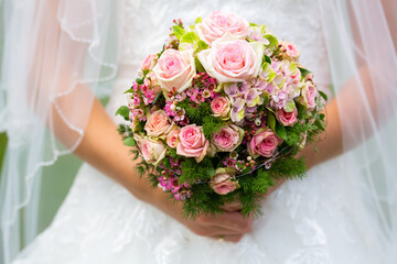 wedding bouquet of flowers in the hands of the bride