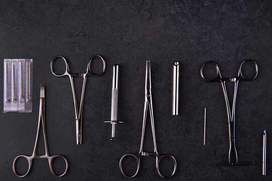 A group of surgical stainless steel body piercing clamps and equipment