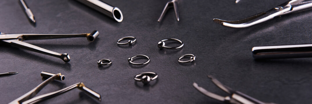 Piercing earrings, stainless steel clips for disinfection on a black background