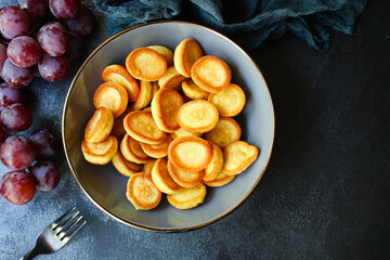 Mini pancakes sweet breakfast snack or dessert Menu concept serving size. food background top view copy space for text organic healthy eating