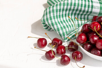 Appetizing ripe cherry on a white table. Close-up.