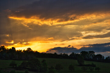Beautiful cloudy sunset over forested hills in the middle of germany