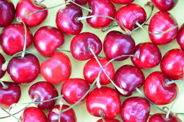 Colourful bright pattern with ripe cherry, flowers and leaf. Top view. fresh organic berries macro fruit background