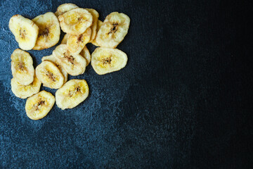 banana chips sweet and healthy snack Menu concept serving size. food background top view copy space for text organic
