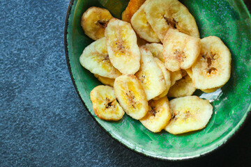 banana chips sweet and healthy snack Menu concept serving size. food background top view copy space for text organic