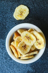 banana chips sweet and healthy snack Menu concept serving size. food background top view copy space for text organic