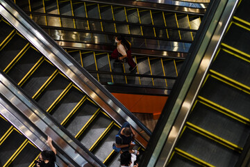 Masked people on escalators