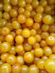 yellow cherry tomatoes in supermarket close-up