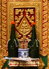 Traditional floral grave decoration made of banana leaves infront of a stupa grave in Siamese Lao PDR, Southeast Asia