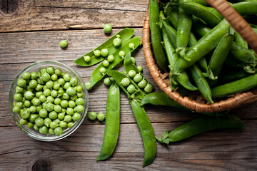 ripe green peas in a bowl on a wooden table