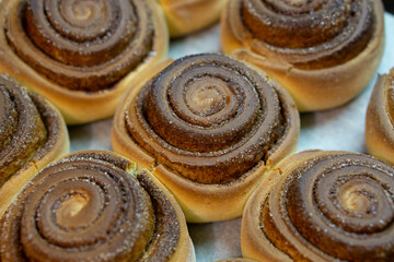 Baked tasty cinnamon rolls also known as cinnabon. Homemade tasty pastry. 