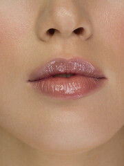 Fototapeta premium Smiling young girl. Beauty face closeup. Sexy lips. Beauty natural lip makeup detail. Beautiful make-up close-up. Sensual open mouth with teeth. Lipstick and lipgloss