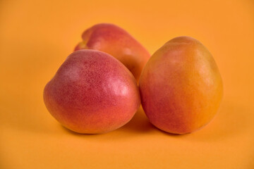 Fresh juicy apricots in a transparent glass plate. Macro.
