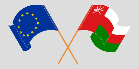 Crossed and waving flags of Oman and the EU